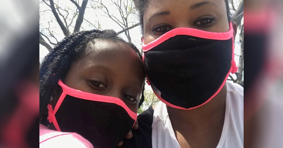 Afiya Wallace and her daughter wearing masks.