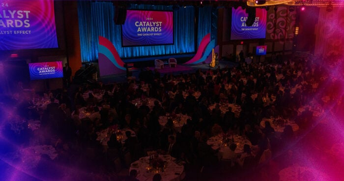 Wide angle view of 2024 Catalyst Awards stage and dinner tables